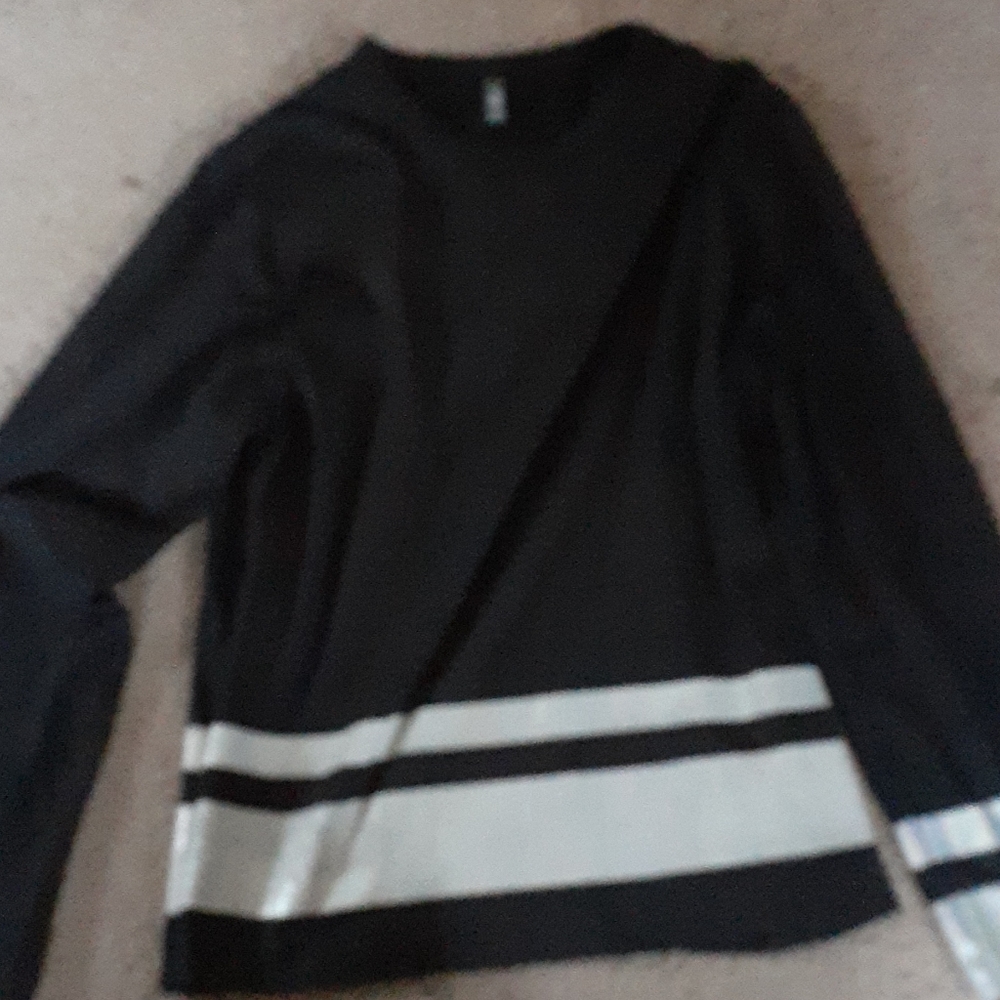 Black long sleeve with holographic design.